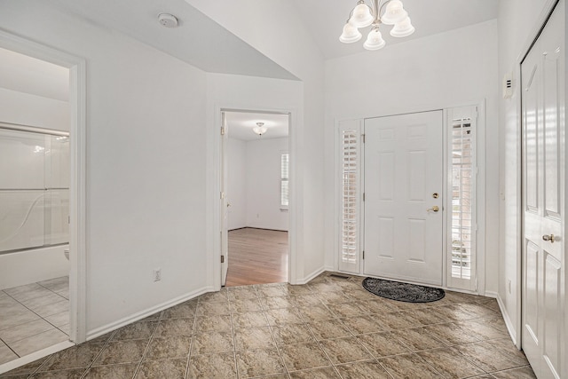 entrance foyer featuring an inviting chandelier and baseboards