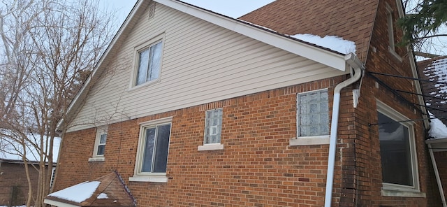 view of side of home with brick siding