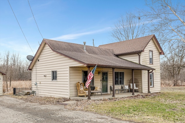 view of front of house with a porch and roof with shingles