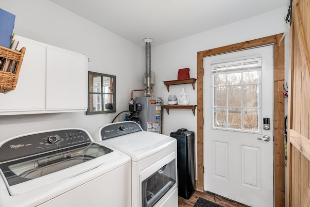 clothes washing area featuring washer and dryer, water heater, cabinet space, and wood finished floors