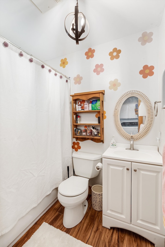 bathroom with shower / tub combo, toilet, wood finished floors, an inviting chandelier, and vanity