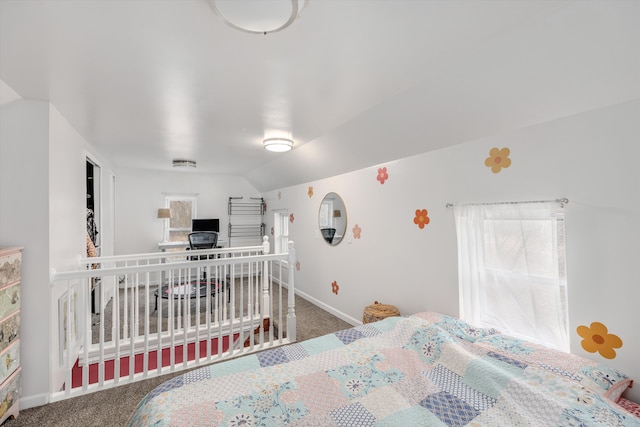 carpeted bedroom featuring multiple windows, vaulted ceiling, and baseboards