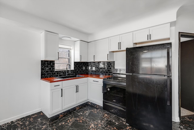 kitchen featuring range with electric cooktop, a sink, white cabinetry, backsplash, and freestanding refrigerator