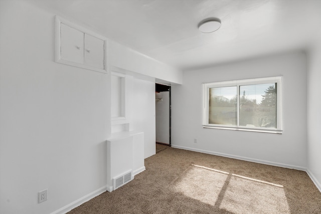 unfurnished bedroom with carpet floors, a closet, visible vents, and baseboards