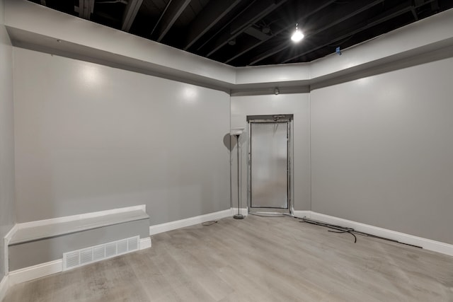 spare room with light wood-style floors, baseboards, and visible vents