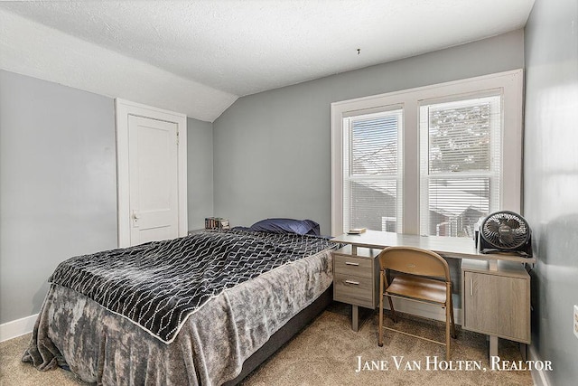 bedroom with a textured ceiling, carpet flooring, lofted ceiling, and baseboards