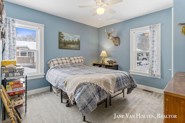 bedroom with light carpet, visible vents, and baseboards