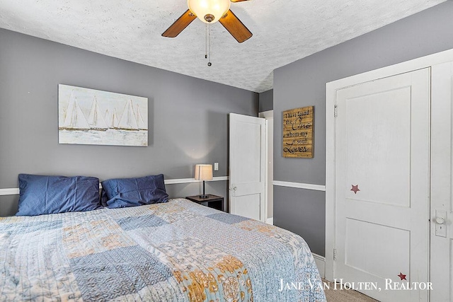 bedroom with a textured ceiling and ceiling fan