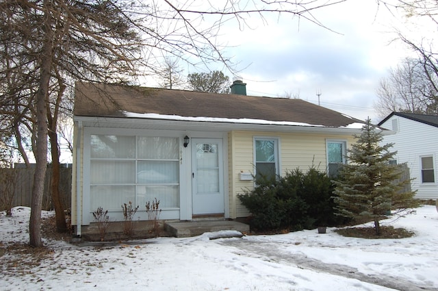 view of front of house featuring a chimney