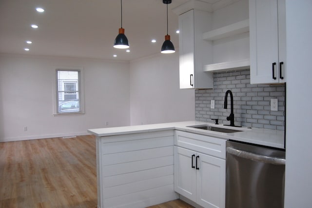 kitchen with open shelves, stainless steel dishwasher, a sink, and white cabinets