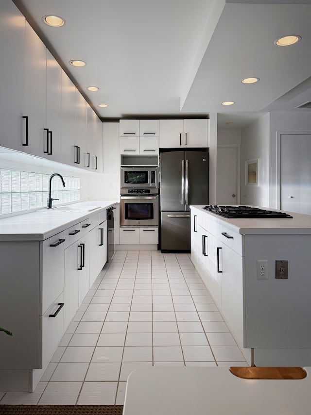 kitchen with light countertops, appliances with stainless steel finishes, and white cabinets