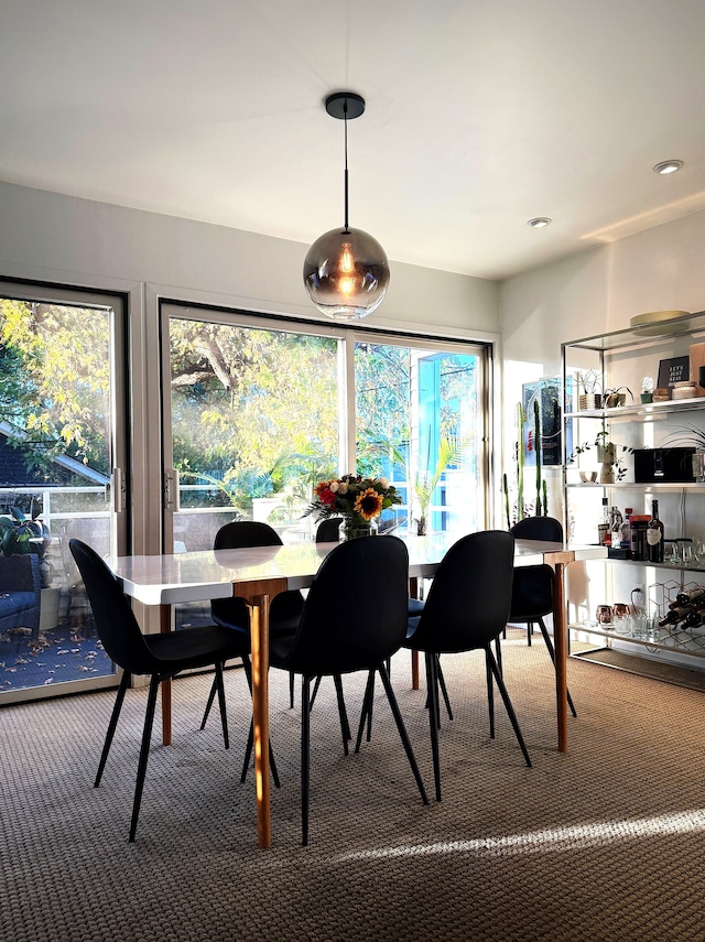 carpeted dining space featuring recessed lighting