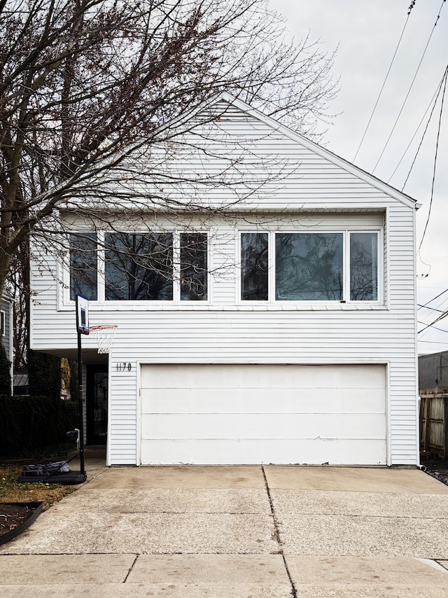 view of side of property featuring a garage and driveway