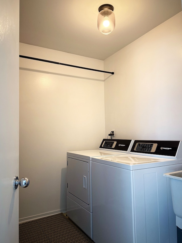 laundry area with laundry area, dark tile patterned flooring, independent washer and dryer, and baseboards