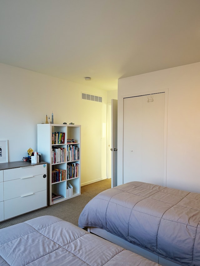 bedroom featuring carpet, a closet, and visible vents