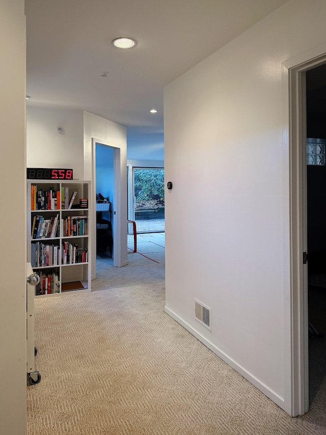 corridor featuring recessed lighting, visible vents, light carpet, and baseboards