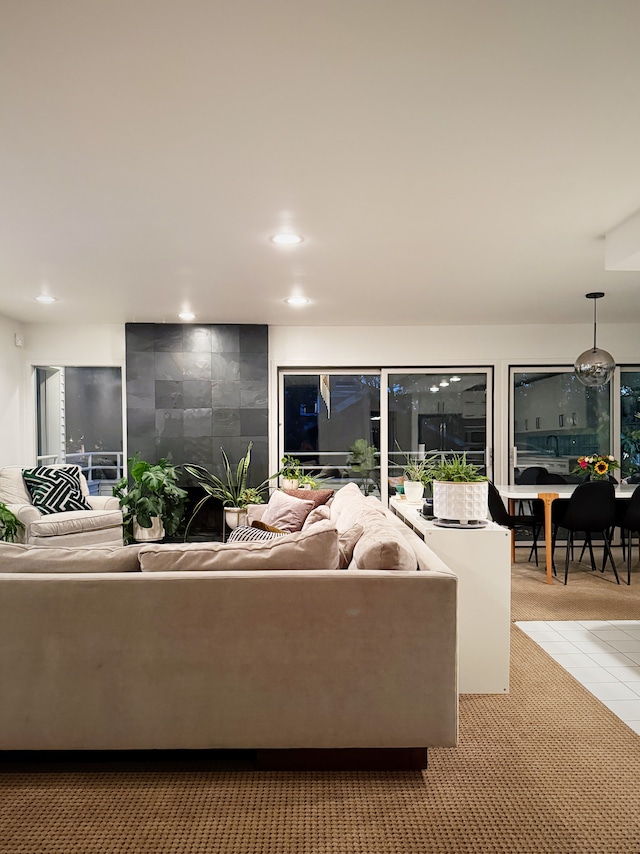 living area featuring recessed lighting and light colored carpet