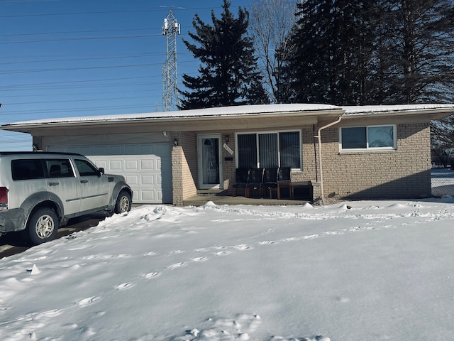 view of front of house featuring a garage, a porch, and brick siding