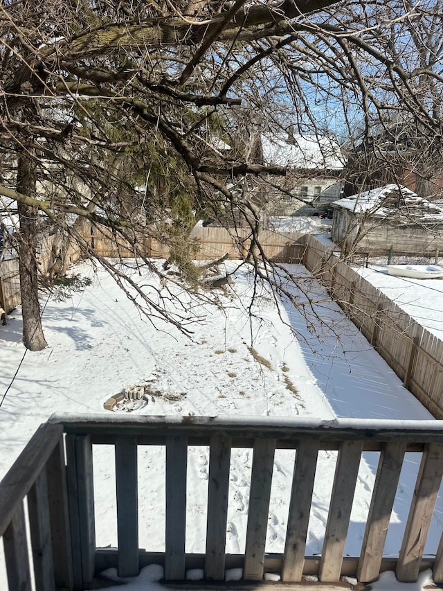 yard covered in snow featuring fence