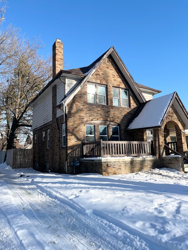 view of front of home with a chimney and fence