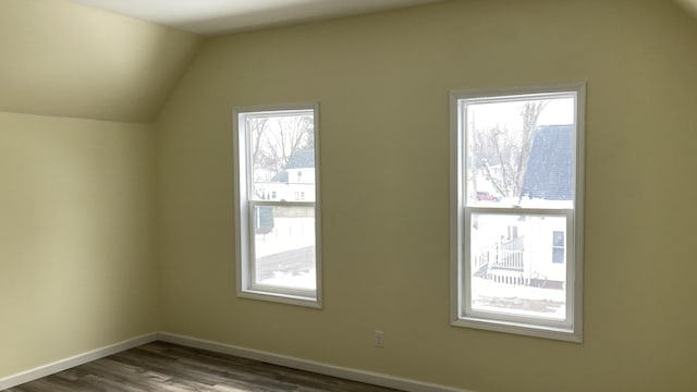 bonus room with vaulted ceiling, baseboards, and wood finished floors