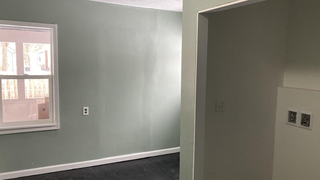 unfurnished room with baseboards