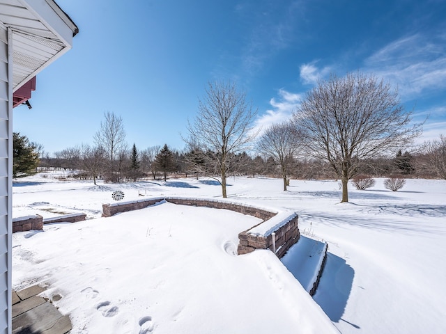 yard covered in snow featuring a garage