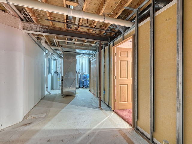 unfinished basement with heating unit and gas water heater