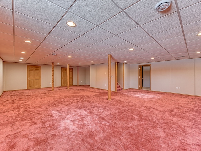 finished basement with baseboards, stairs, carpet flooring, a paneled ceiling, and recessed lighting