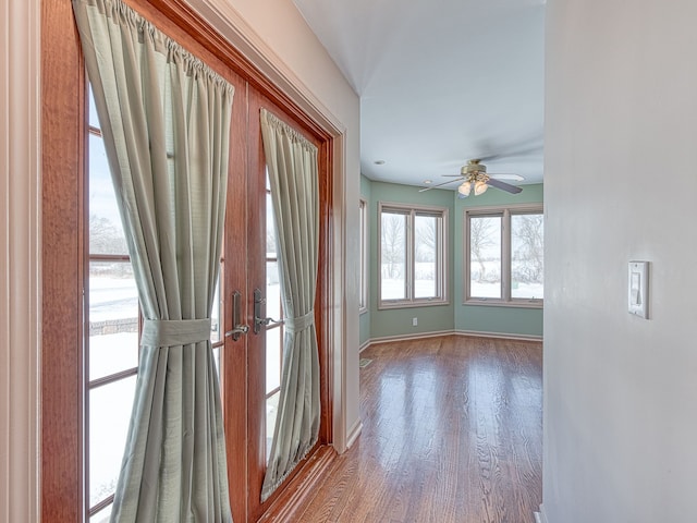 interior space with baseboards and wood finished floors