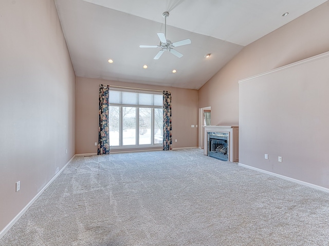 unfurnished living room featuring ceiling fan, high vaulted ceiling, light colored carpet, a fireplace, and baseboards