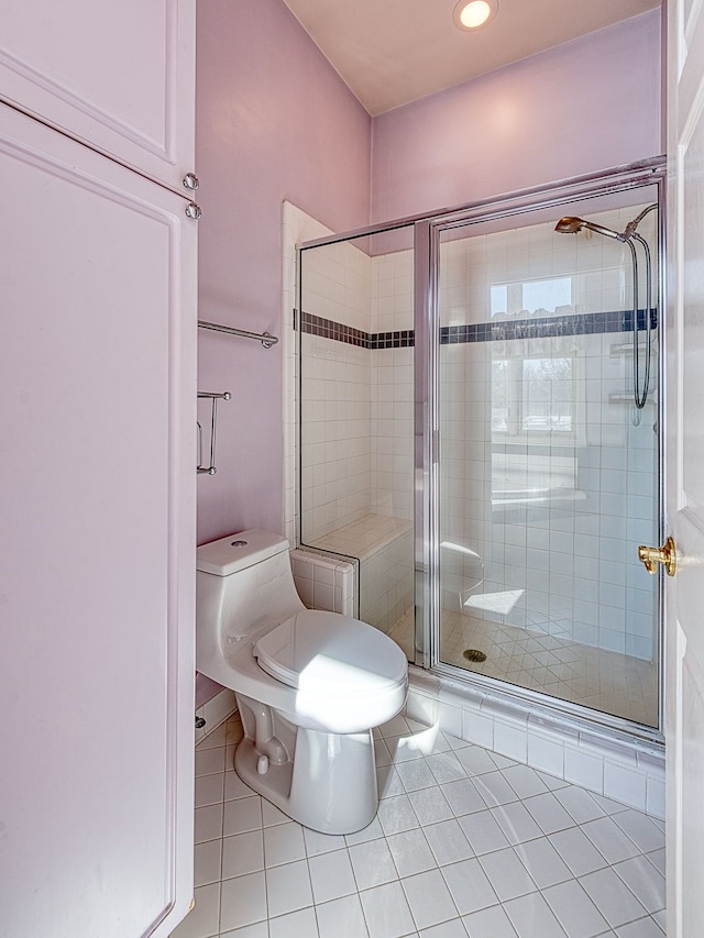 bathroom with a stall shower, recessed lighting, toilet, and tile patterned floors