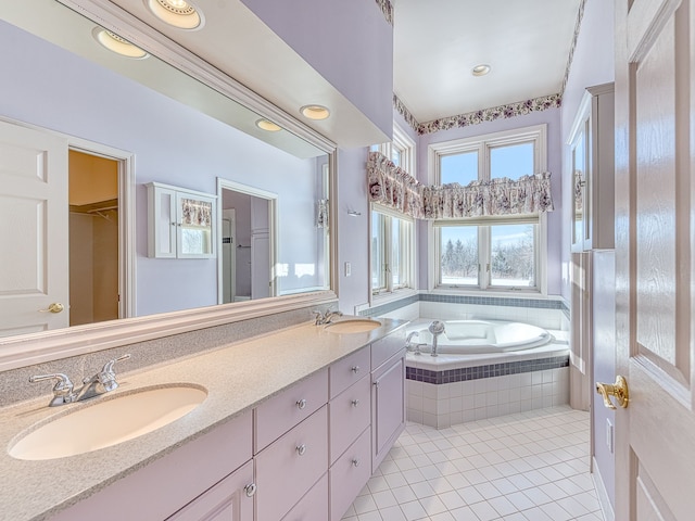 bathroom featuring double vanity, a sink, a bath, and tile patterned floors