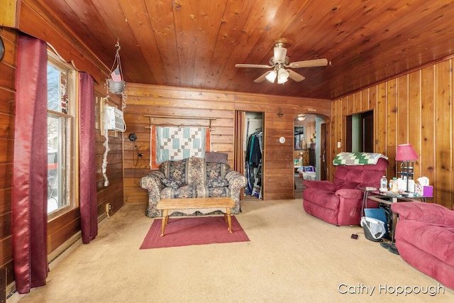 living room featuring wood ceiling, wood walls, plenty of natural light, and a baseboard heating unit