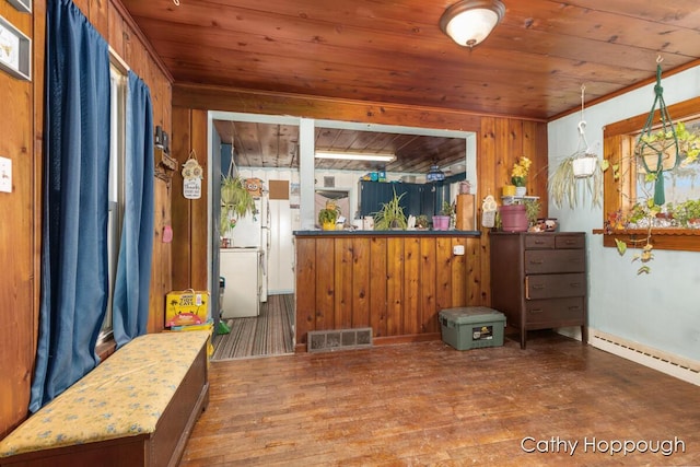 interior space with wooden walls, wood finished floors, wood ceiling, visible vents, and hanging light fixtures