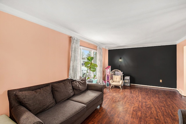 living room featuring crown molding, baseboards, and wood finished floors