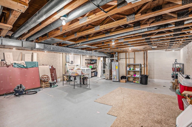 unfinished basement featuring washer / dryer, electric panel, and gas water heater