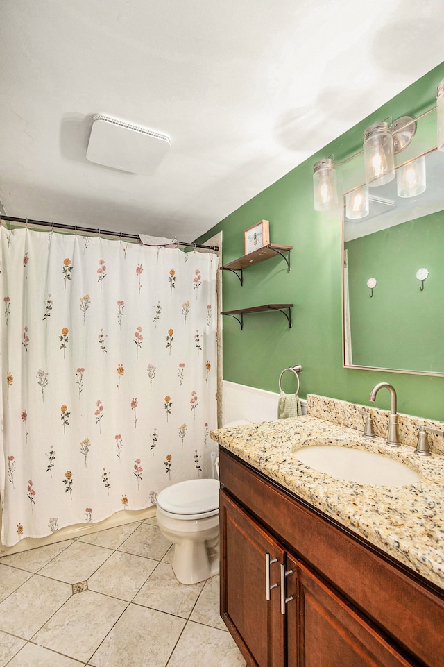 full bathroom featuring curtained shower, vanity, toilet, and tile patterned floors