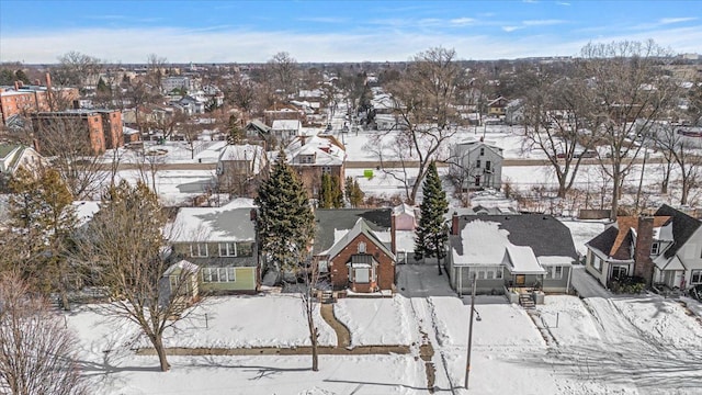 snowy aerial view with a residential view