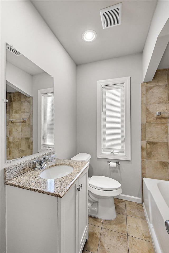 bathroom featuring visible vents, vanity, toilet, and tile patterned floors