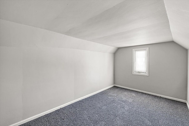 bonus room with lofted ceiling, carpet flooring, and baseboards