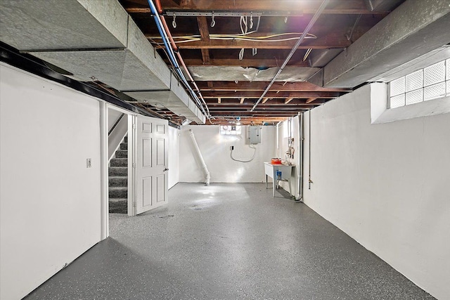 basement with electric panel and stairs