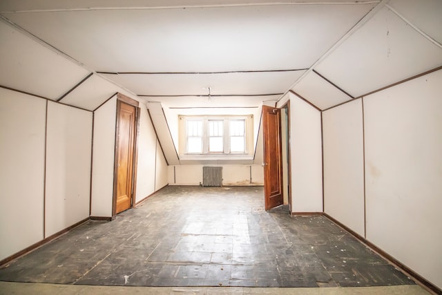 bonus room with lofted ceiling and radiator