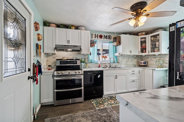 kitchen with dishwasher, light countertops, a sink, and double oven range