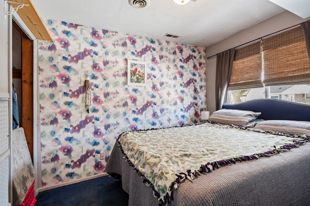 carpeted bedroom with baseboards and visible vents