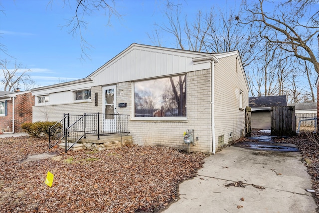 view of front of house with brick siding and fence