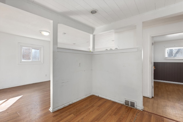 spare room with wood ceiling, hardwood / wood-style floors, and visible vents