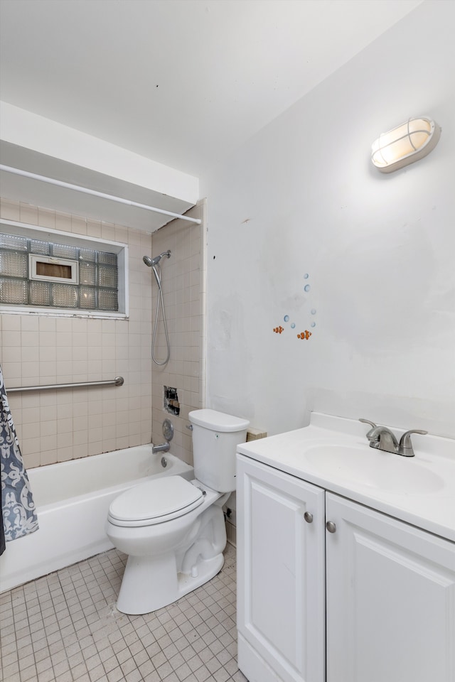 bathroom featuring tile patterned flooring, vanity, toilet, and shower / bath combo with shower curtain