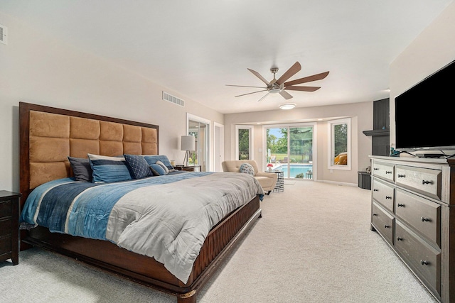 bedroom featuring light carpet, access to exterior, visible vents, and a ceiling fan