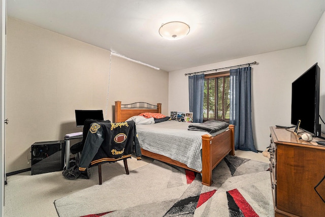 bedroom featuring light colored carpet